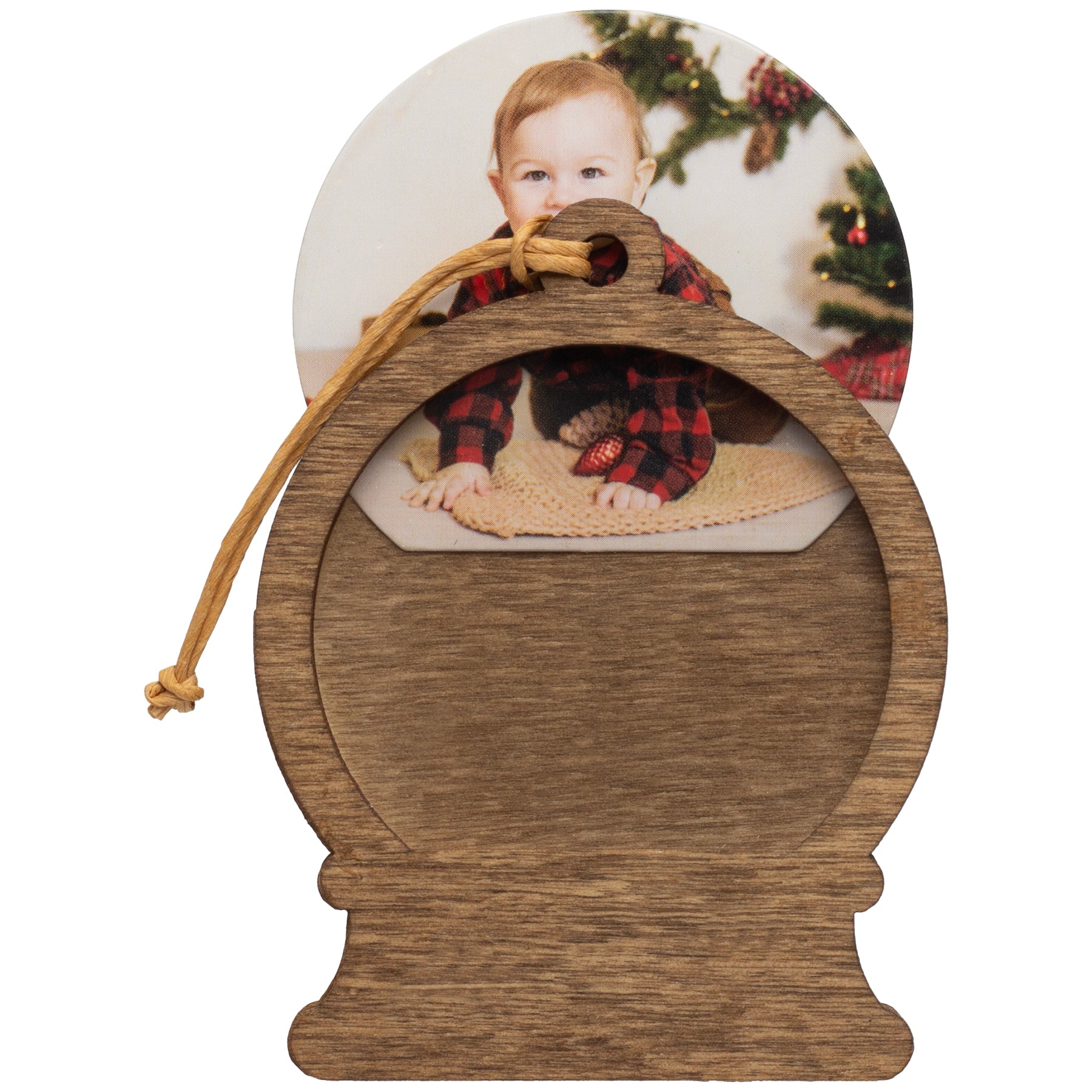 A wooden snow globe-shaped photo ornament with a picture being inserted into the ornament.