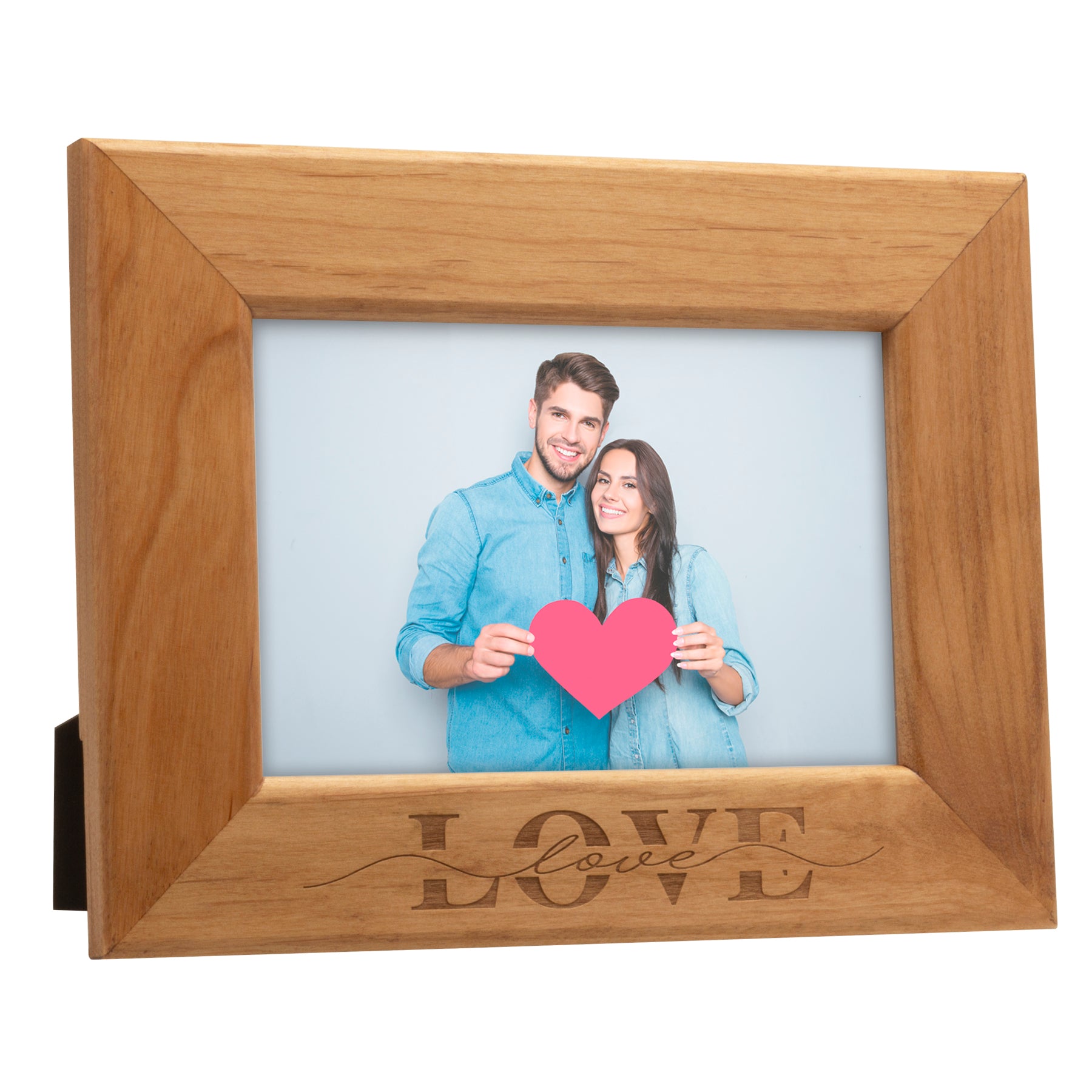 Brown wood photo frame shown on an angle with 'LOVE' engraved on the bottom holding a photo of a couple with a heart.