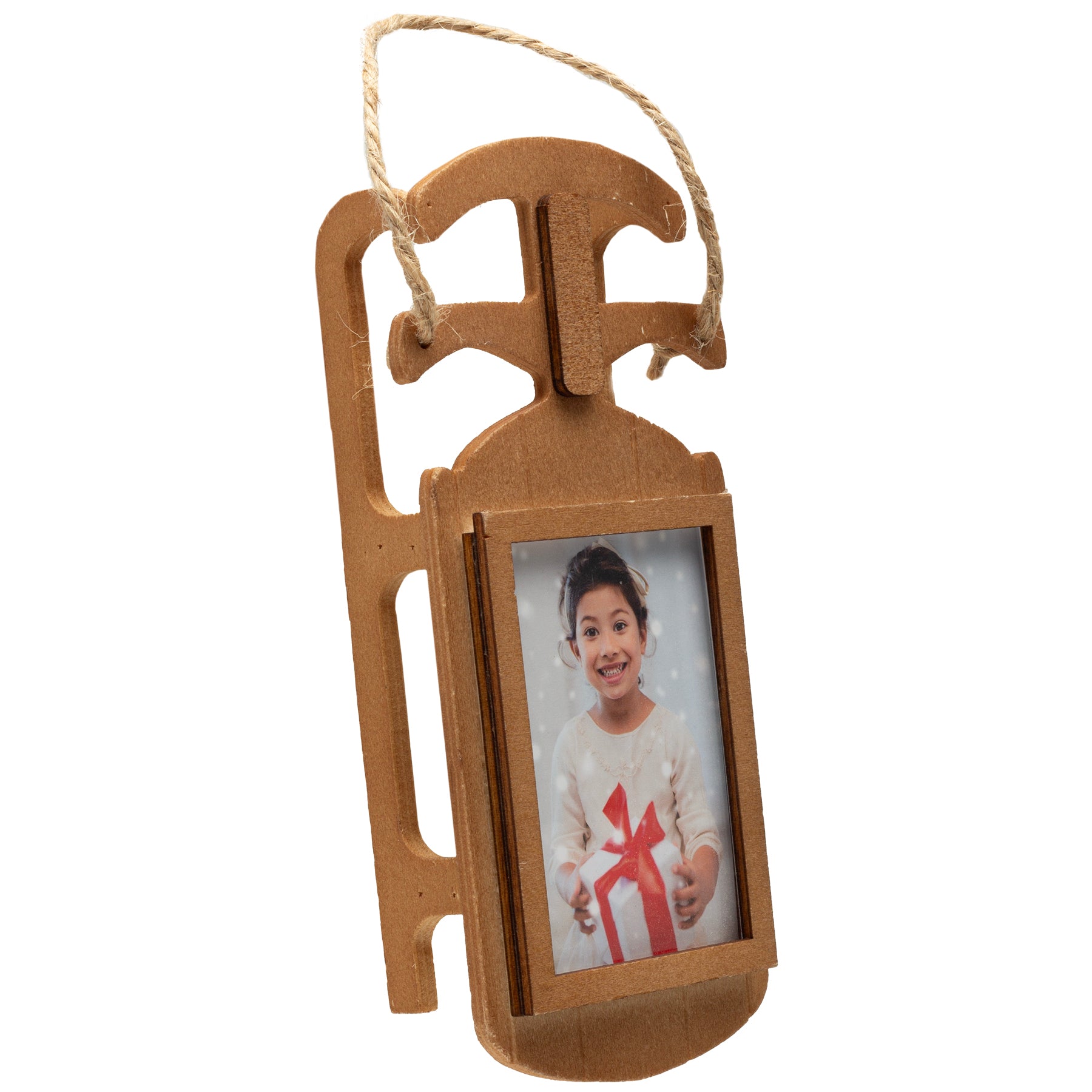 The side view of a wooden sled-shaped photo ornament with a loop of twine used to hang the ornament on a Christmas tree.