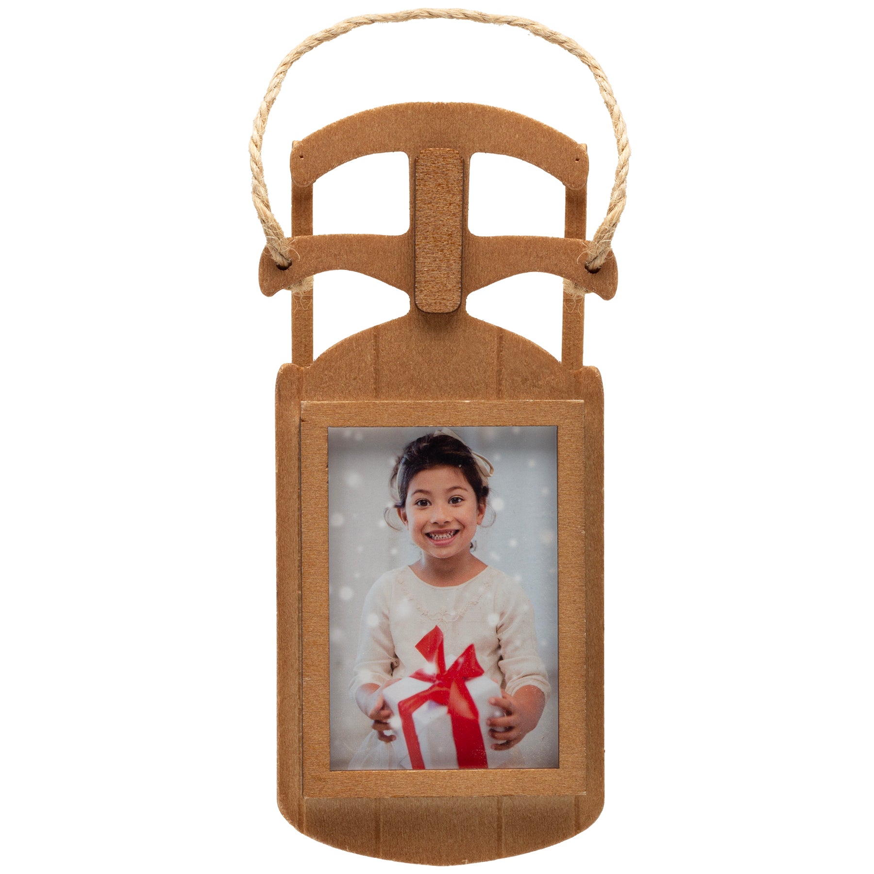 A wooden sled-shaped photo ornament with a loop of twine used to hang the ornament on a Christmas tree.