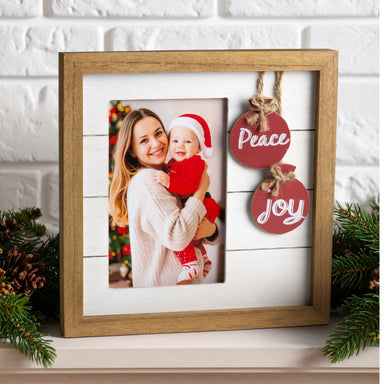 Wood Christmas photo shown in a home on a shelf or mantel during the holiday season.