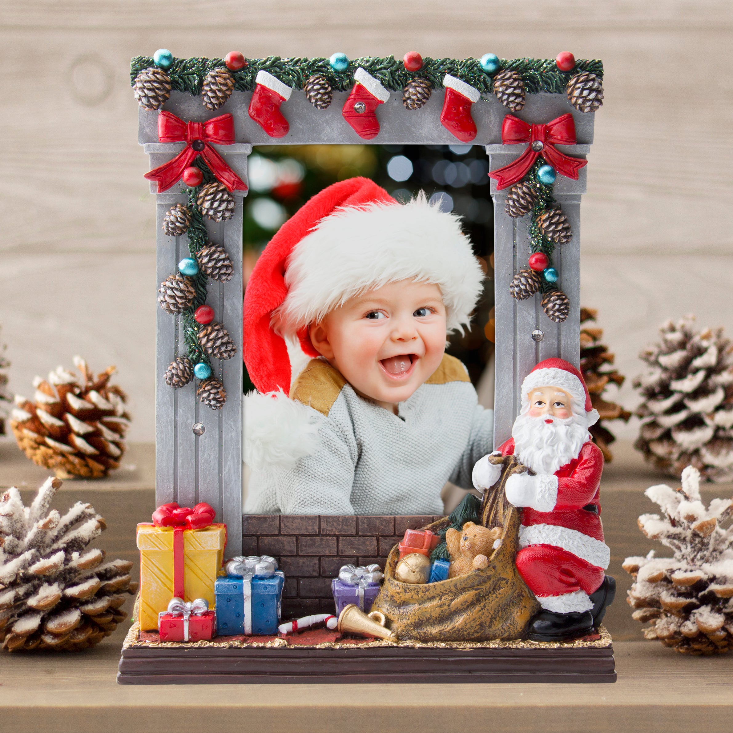 A gray colored light-up resin picture frame with hand painted details featuring garland, stockings, presents, Santa, and more on festive lifestyle background.