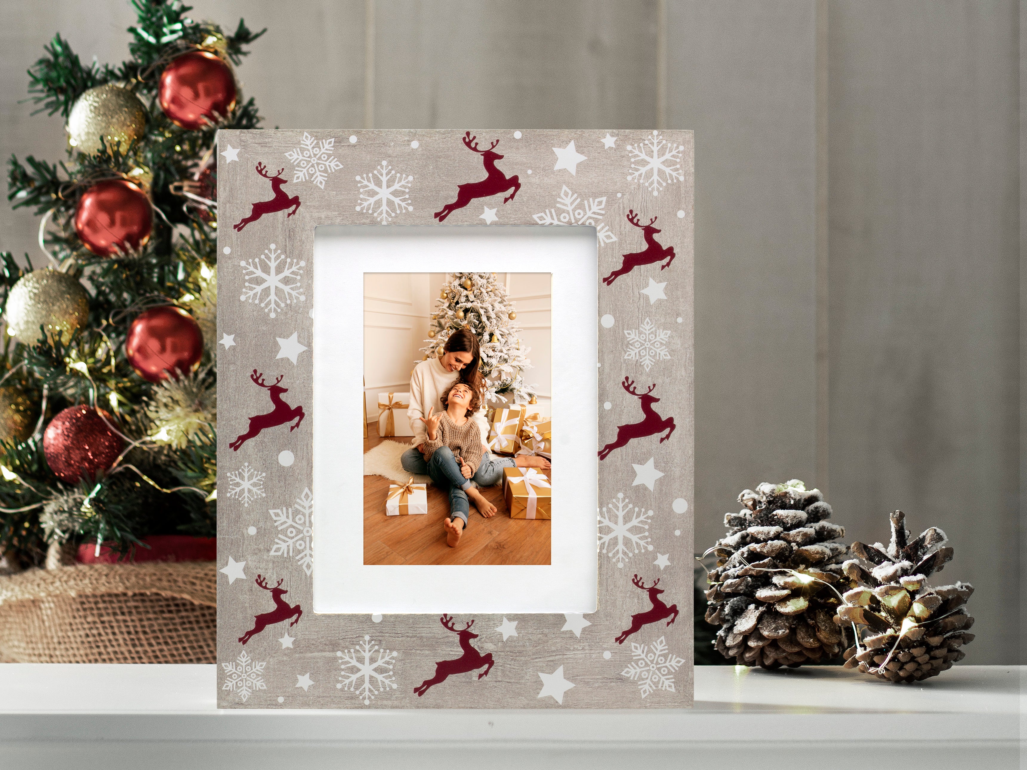 A rustic wooden picture frame with a reindeer and Christmas-themed pattern on a festive lifestyle background.
