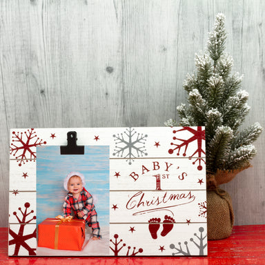 A wooden clipboard picture frame with a Christmas theme, featuring the text 'Baby's 1st Christmas' decorated with snowflakes and stars on a festive lifestyle background.