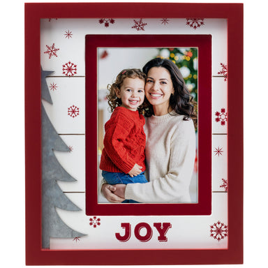 Photo of a woman and child in a red and white wood picture frame with 'JOY' text, surrounded by Christmas-themed decorations.