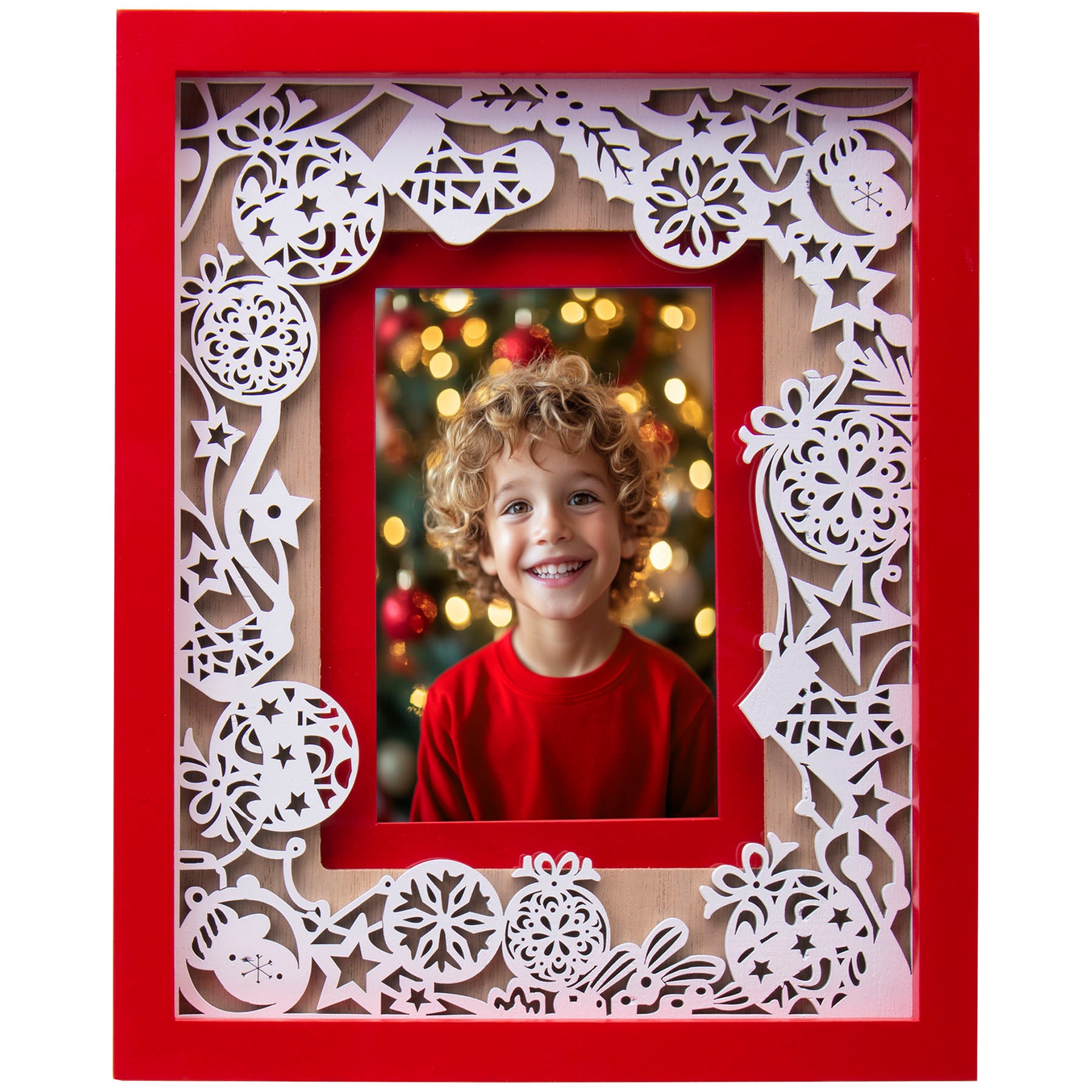 A red and white Christmas-themed laser cut picture frame with ornaments and a photo of a child standing in front of a Christmas tree wearing a red shirt.