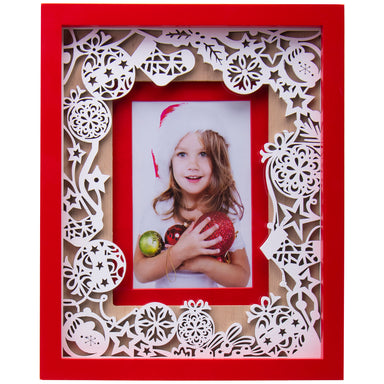 A red and white Christmas-themed laser cut picture frame with ornaments and a photo of a child wearing a Santa hat holding a Christmas tree.