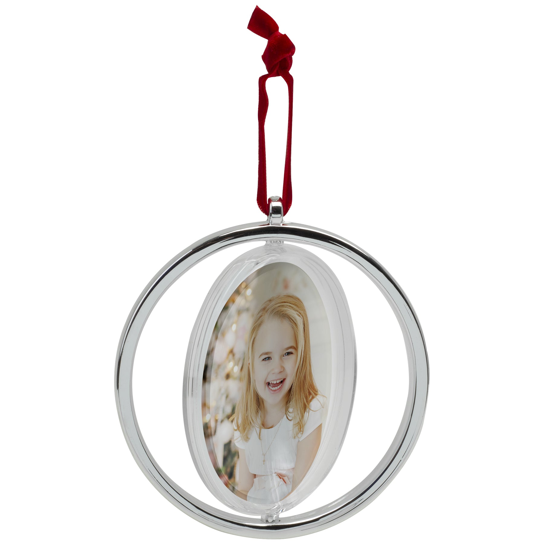 One photo ornament attached to red velvet string, mid-spin, on a white background.