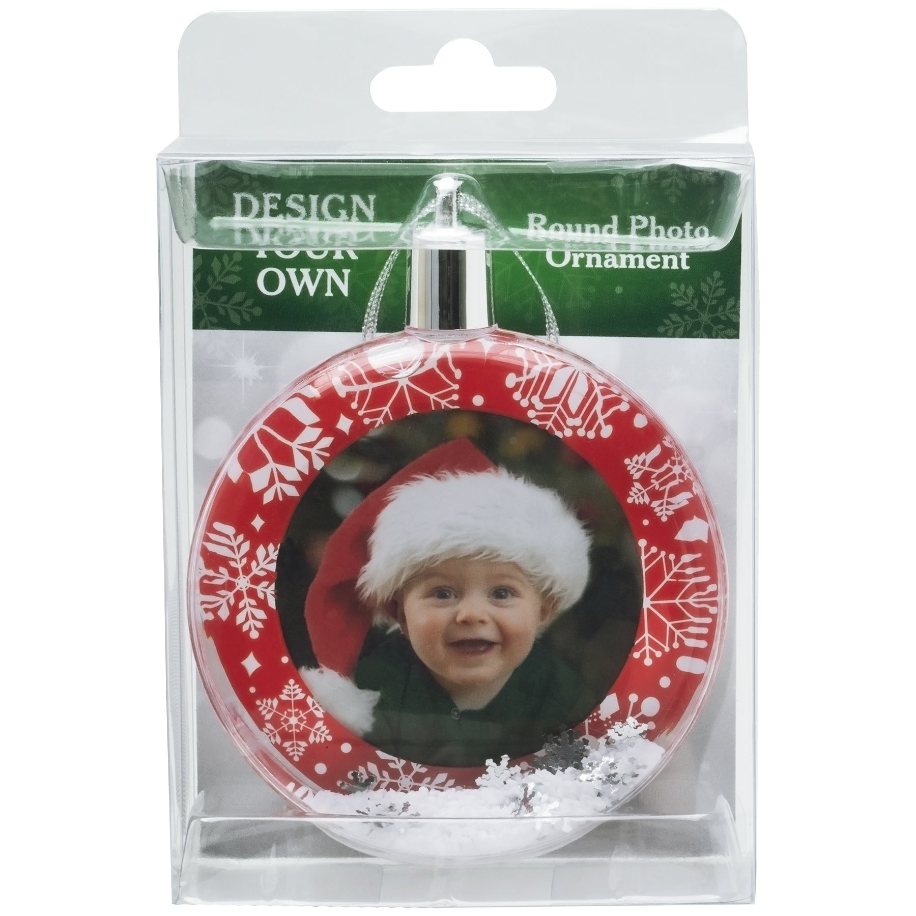 A round snow globe photo ornament with a red border and white snowflakes in full-color retail packaging.