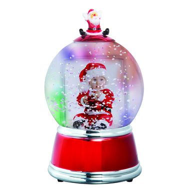 A holiday themed photo snow globe with LED lights. The globe is clear with a Santa figurine on the top, and the base is red with silver trim displayed on a white background.