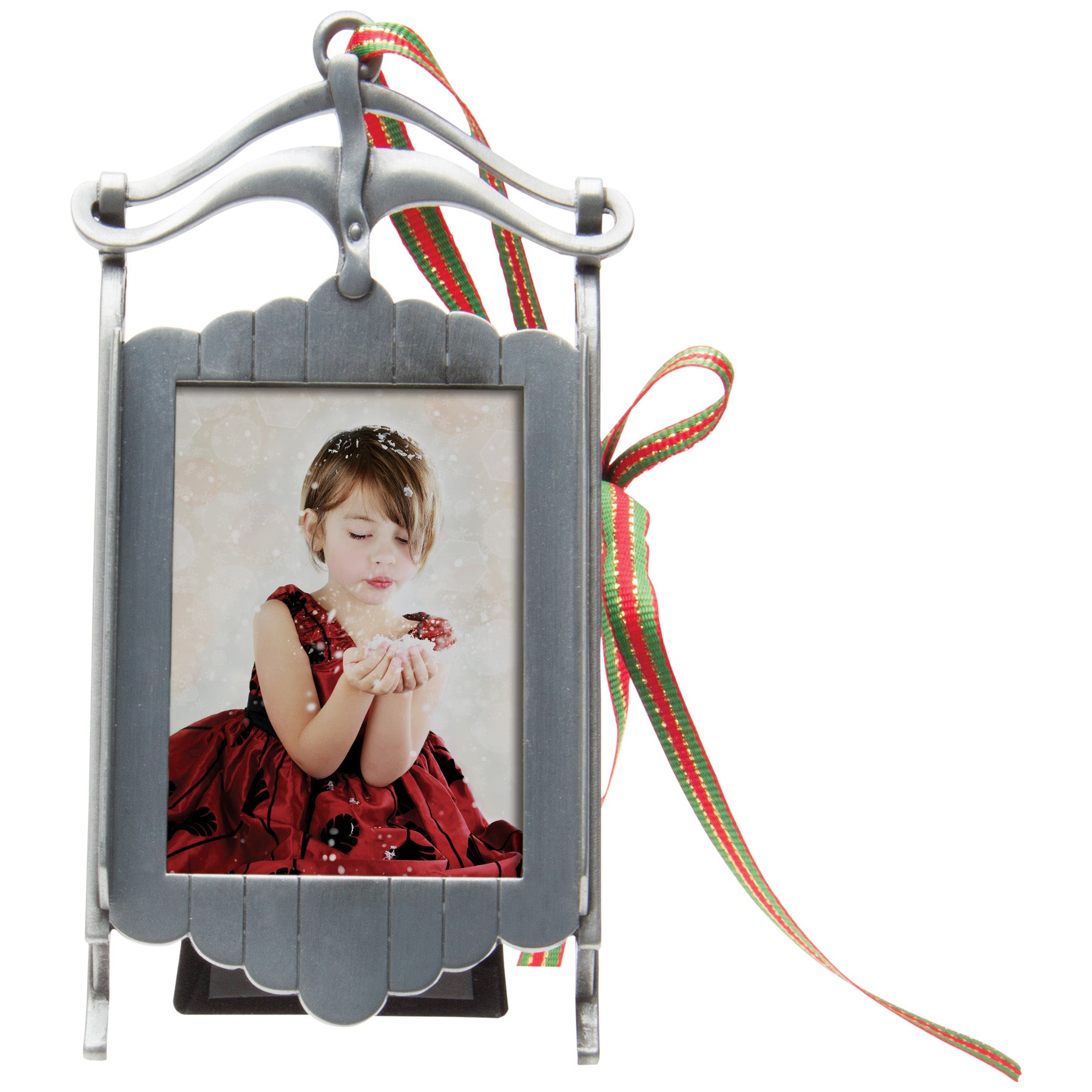 A pewter sled-shaped photo ornament and picture frame adorned with a red, green, and gold ribbon displayed on a white background.