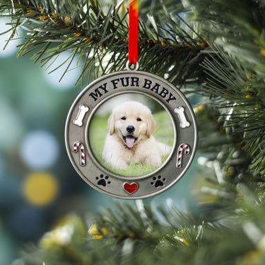 A pewter photo ornament with the text 'MY FUR BABY' featuring a picture of a dog, adorned with colorful enamel dog bones, candy canes, and paw prints hanging on a Christmas tree by a red velvet ribbon.