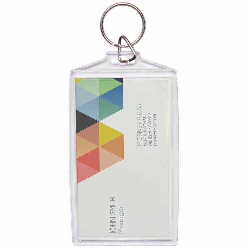 A clear plastic keychain with a snap-in business card holder containing two business cards used for self promotions.