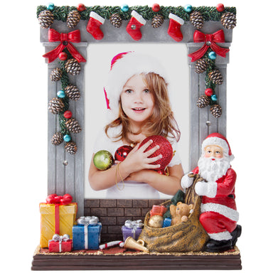 A gray colored light-up resin picture frame with hand painted details featuring garland, stockings, presents, Santa, and more on a white background.