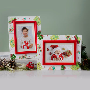 A wooden picture frame with a shiplap design and a rustic worn finish, featuring white as the base color with red trim, decorated with painted Christmas presents and gifts showcasing vertical and horizontal orientations on a festive lifestyle background.